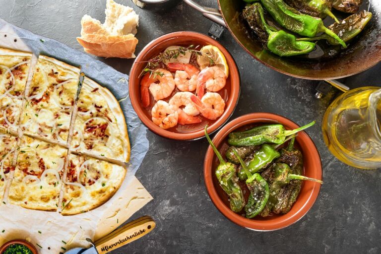 Spanish tapa bowls with fried pimientos or padron peppers and sh